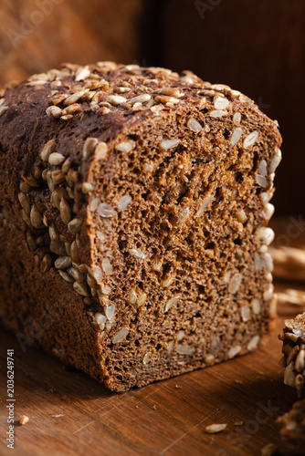 Rye bread with sunflower seeds on wooden cutting board, rustic style bread