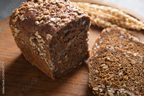 Rye bread with sunflower seeds on wooden cutting board, rustic style bread