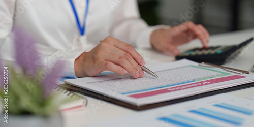 Canvas-taulu Person calculating finance data on accounting spreadsheet in office