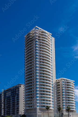 tall modern buildings in white and blue in a big city