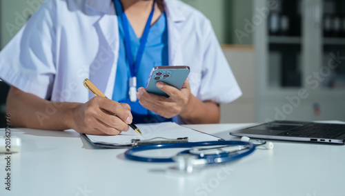 Medical students working with Laptop and hospital documents.