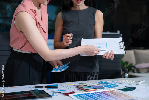 Fotografía UX developer and ui designer brainstorming about mobile app interface wireframe design with customer breif and color code at office