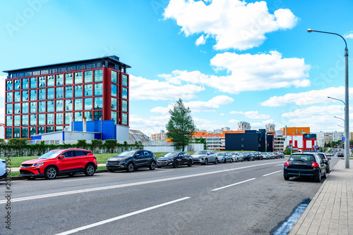 Cars parked along the road at the curb in the city.