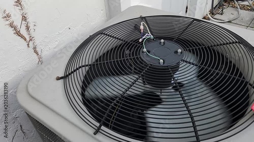 Air conditioner condenser fan running in residential outdoor area