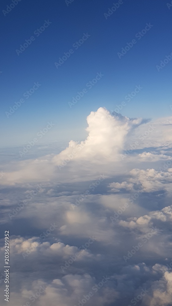 Fototapeta premium Cloud formation in blue sky above fluffy altostratus layer 