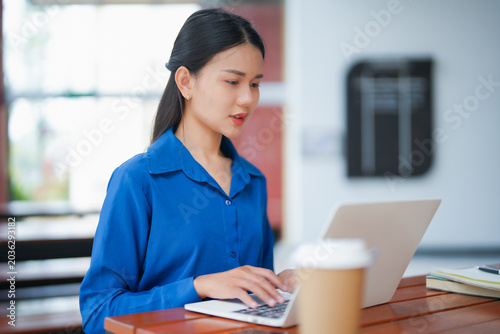 Bild auf Leinwand Asian businesswoman typing on laptop working from anywhere