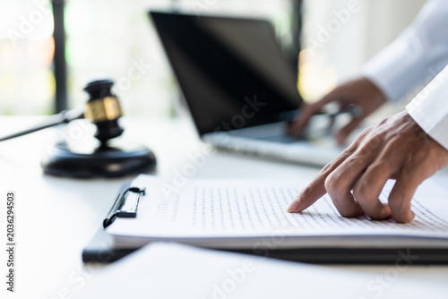 Lawyer businessman working with lawbook in office or courtroom Legal counsel with gavel and legal law. justice and lawyer concept Judge gavel hammer on Lawyer desk.