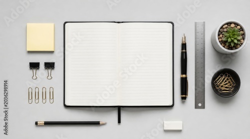 Hero shot of open journal and stationery on desk