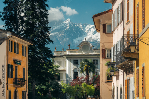 Chiavenna old town against snowcapped mountains in spring, Lombardy, Italy