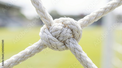 Macro close up of white rope knot on soccer goal net