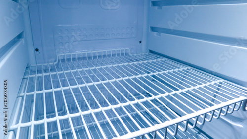 Schilderij op canvas Interior view of an empty clean refrigerator looking slightly to the right side