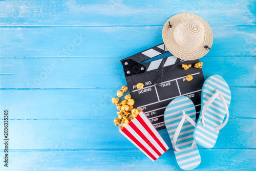 Summer holiday and vacation movie cinema marathon background Cinema clapper-board with sunglasses, seashells, starfish, popcorn buckets, vacation accessories, Cinema for the summer Movie Night party