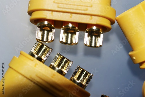 Εκτύπωση καμβά Close-up of bright yellow MR60 connectors, showcasing their shiny gold-plated pins for high-power electric motor connections