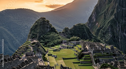 Ancient stone ruins of Machuigenicchu nestled between lush green mountains and valleys at sunrise