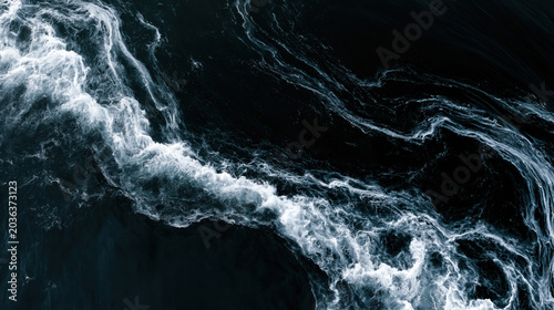 Dark ocean surface with abstract white wave patterns