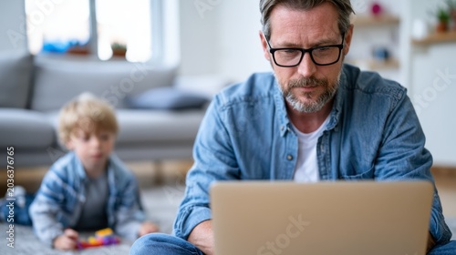 Man with glasses focuses on laptop. Child sits nearby, curious and quiet. Cozy living room with soft lighting. Warm tones suggest comfort and family time. Ideal for parenting, home office