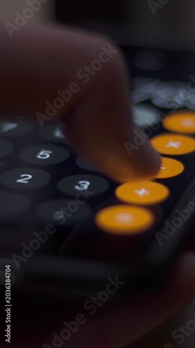 Finger Pressing Buttons on Smartphone Calculator App Close Up