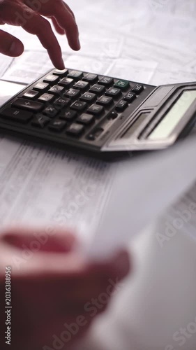 Accountant Hands Using Desktop Calculator and Checking Invoices