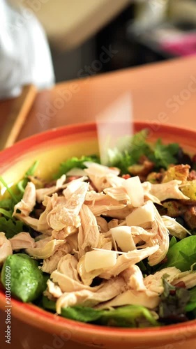 Gourmet Italian Caesar Salad Making: Grating Fresh Parmesan Cheese over Salad