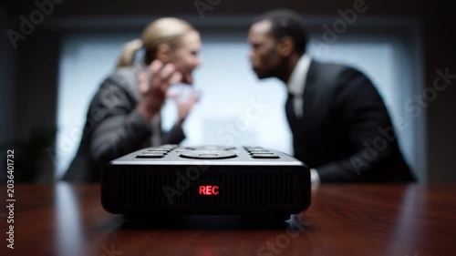 Business meeting argument and conflict with voice recorder during negotiation stress office, coworkers debating businessman and businesswoman workplace dispute, tense interrogation style crisis