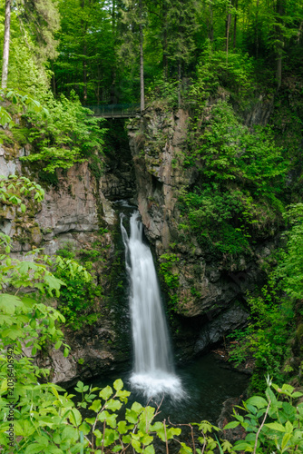 A mountain waterfall in the forest. Wilczki Waterfall, Sudetes Mountains (Sudety).