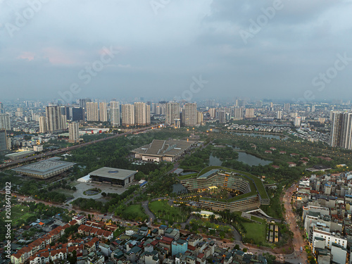 Wide aerial panorama of Cau Giay District with modern urban complexes, green parks, and dense residential development in Hanoi.