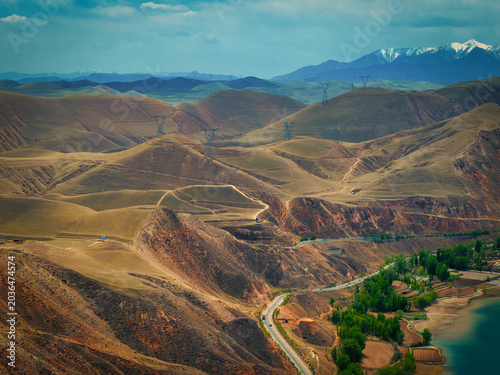 Bild auf Leinwand Silk Road Wilderness Beneath the Qilian Mountains: Winding Roads and Transmissio