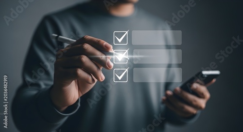 Man's hand with a pen checking off items on a glowing virtual checklist, while holding a smartphone, illustrating digital task completion, online surveys, and efficient workflow.