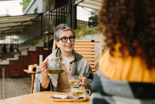 Принти на полотні Mature woman enjoying tea with younger friend