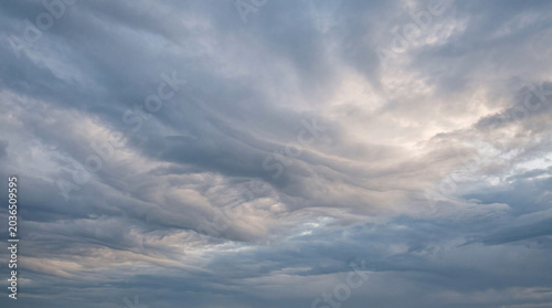 Photography Dramatic and powerful grey storm clouds gathering in a vast, moody sky