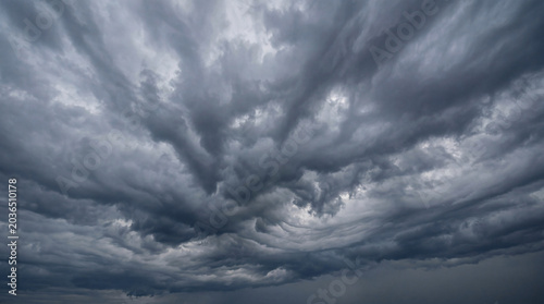Schilderij op canvas Dark and ominous storm clouds gathering in a turbulent sky, conveying intense weather and impending atmospheric drama