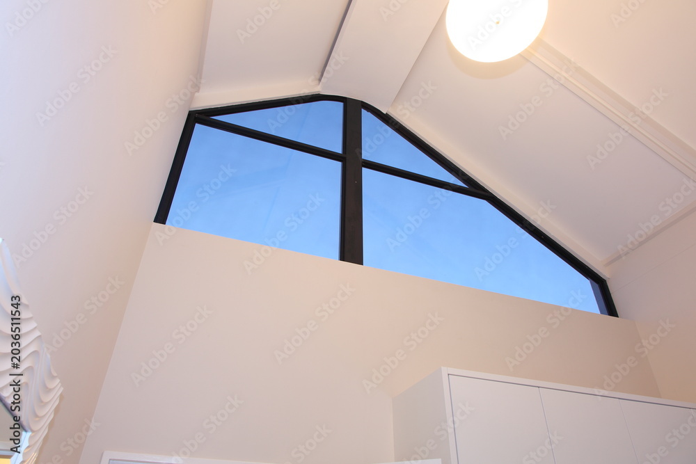 Fototapeta premium A high white ceiling, with a feature window and skylight. 