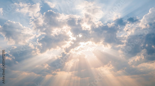 Photography Majestic sun rays breaking through dramatic, dark clouds, creating a powerful and inspiring crepuscular light effect