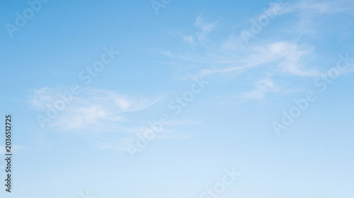 Tableau sur toile Gentle light blue sky adorned with delicate, swirling white wisps of cirrus clouds