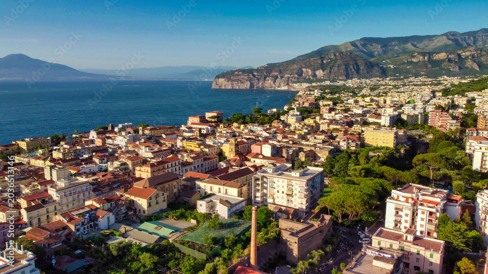 Fototapeta premium Cinematic drone view of Sorrento coastal town at sunset in Campania
