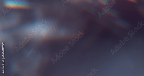 Slow motion of lens flare isolated on black background. Colored spectrum. Cinematic glowing light overlay with optical streaks and rays for VFX compositing and transitions.