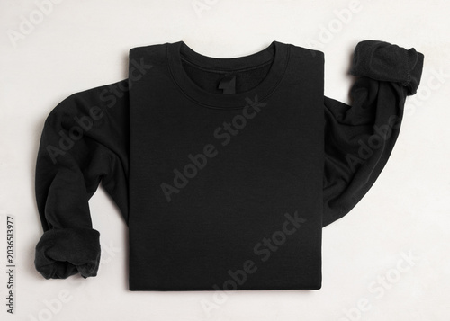 Blank black unisex sweatshirt mockup, folded apparel template with copy space on front