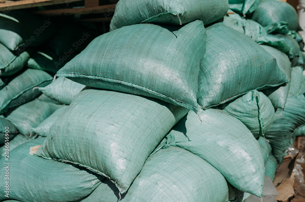 Fototapeta premium Pile of soil filled bags at construction site