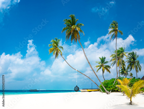 Vacation summer holidays leisure background - sunny tropical Caribbean paradise resort beach with white sand, lounger, palms on Maldive