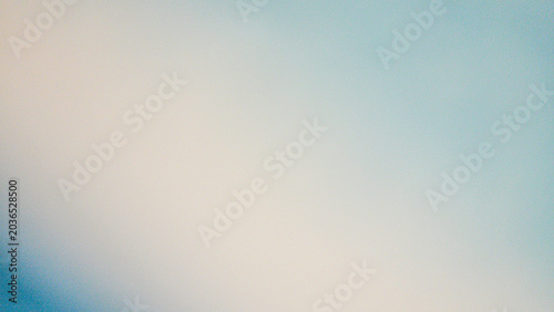 Smooth abstract background featuring a soft, out-of-focus gradient transitioning from light warm cream on the left to pale, icy cyan blue on the right.