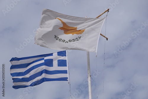 Photos Close up of the Cyprus flag and the Greek flag waving in the wind in front of a