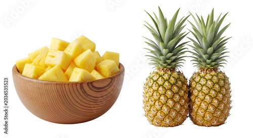 Fresh pineapple and cubed pineapple in wooden bowl on black background