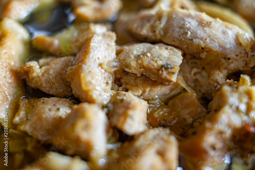 Close-up of juicy braised pork chunks in savory sauce