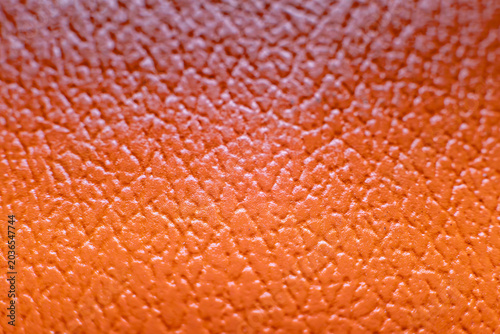 Orange textured leather surface macro background