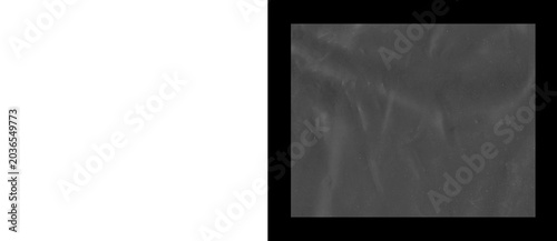 Fotografie Crumpled black plastic texture, wrinkled dark polyethylene film background, macr