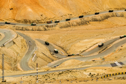 Indian Military trucks passing through Zigzag road, famously known as jilabi road at old route of Leh to Srinagar Highway, Ladakh, Jammu and Kashmir, India. Scenic and popular route through mountains.