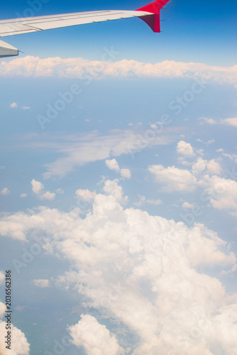 White clouds in sky with aeroplane wing. Image shot from flying aeroplane , cloudscape of India.