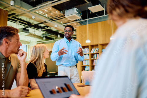 Fotografie Business team meeting in a modern office, an African American man presenting dat