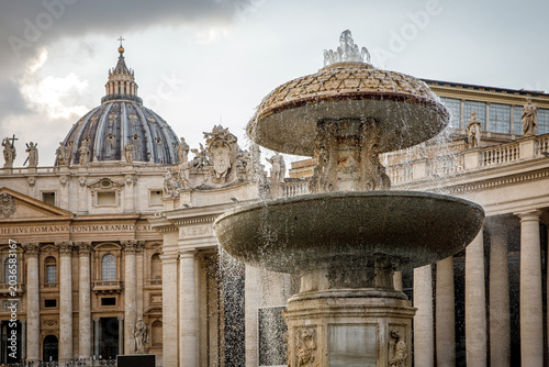 Fountain in Saint Peters Square with the Vatican Basilica dome