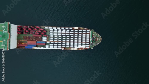 Top View A transport ship is loaded with many cars at the Halifax port in Nova Scotia. The ship is preparing to export the cars to various locations. Busy days like this are common here